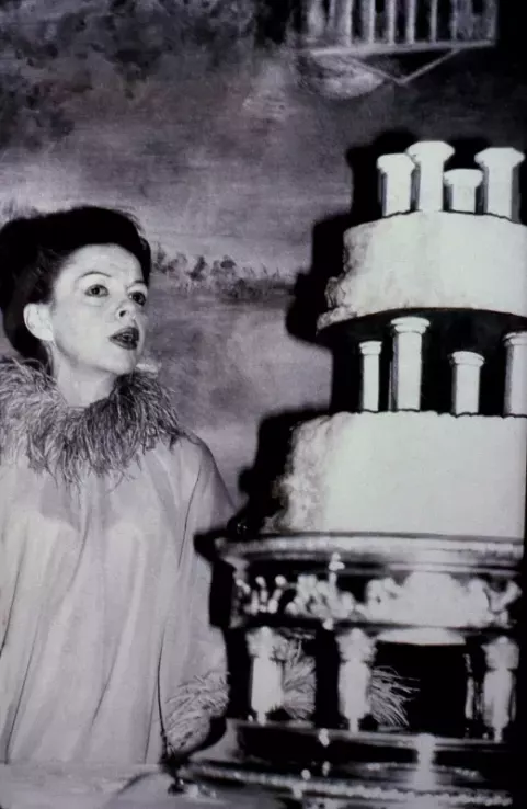 Judy Garland at 'Quaglinos' Jermyn Street London on her wedding day with her wedding cake (1969)